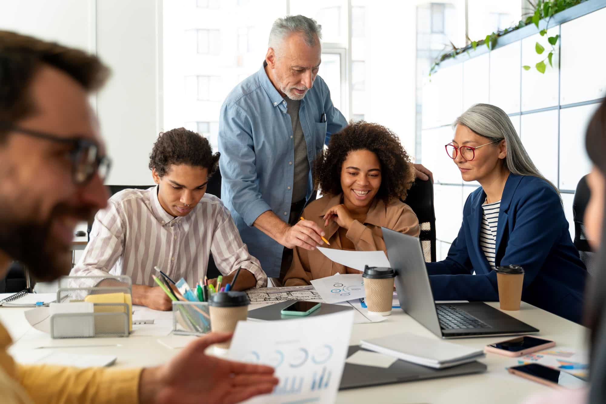 male employee leading a group meeting at a conference table